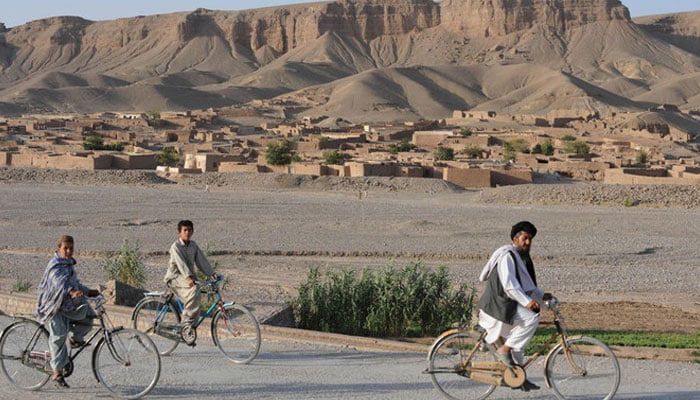 Pakistani commuters ride past on a road in Pishin, about 50 kilometres north of Quetta, Balochistan on July 19, 2011. — AFP
