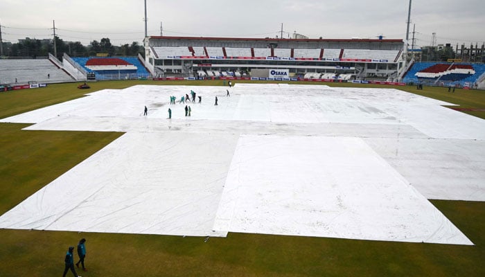 Ground staff remove rain water from the pitch during the third day of the first Test cricket match between Pakistan and Sri Lanka at the Rawalpindi Cricket Stadium. — AFP/File