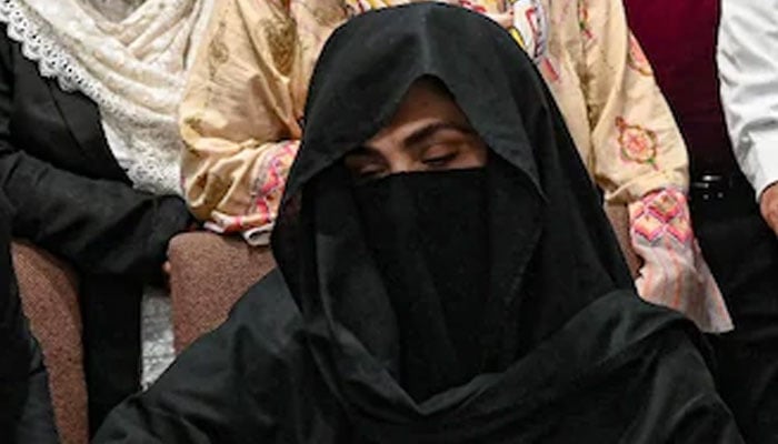 Bushra Bibi signs a surety bond (not pictured) for bail in various cases at the registrars office at the Lahore High Court on July 17, 2023. — AFP