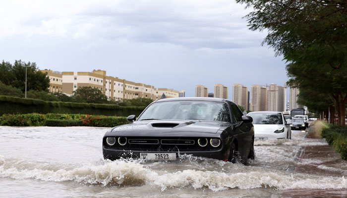 Cars drive through water in a flooded street following heavy rains in Dubai, United Arab Emirates, April 16, 2024. — Reuters