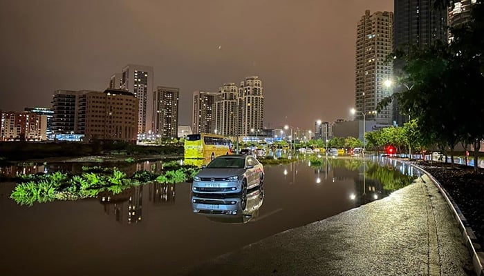 A car is left on a flooded street following heavy rains in Dubai early on April 17, 2024. — AFP