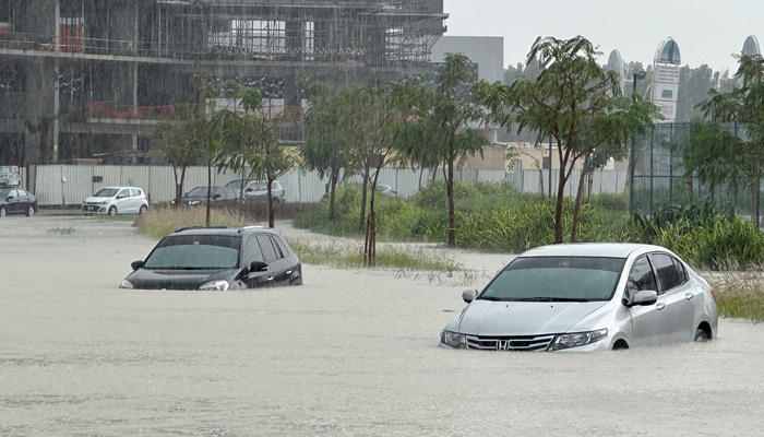 Cars drive through a flooded street during a rain storm in Dubai, UAE, April 16, 2024. — Reuters