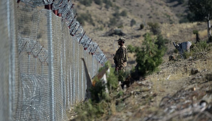 A Pakistani soldier keep vigil next to newly fenced border fencing along with Afghans Paktika province border in Angoor Adda in South Waziristan on October 18, 2017. — AFP