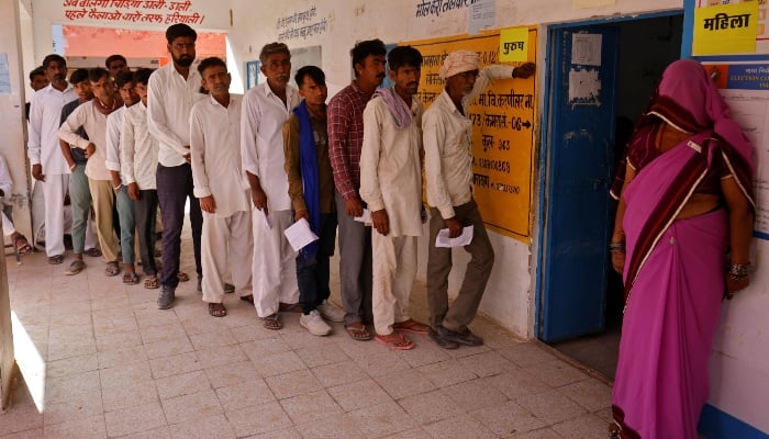 People wait to cast their votes at a polling station during the first phase of the general election, in Bikaner district, Rajasthan, India, on April 19, 2024. —Reuters