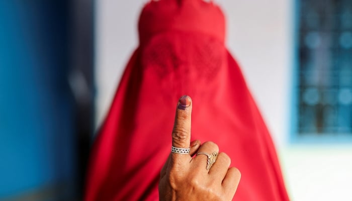 A woman clad in a burqa shows her ink-marked finger after voting at a polling station during the first phase of the general election in Kairana, in the northern Indian state of Uttar Pradesh, India, on April 19, 2024. —Reuters