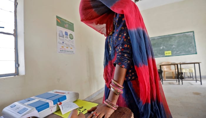 A woman gets her finger inked before casting her vote at a polling station during the first phase of the general election, in Bikaner district, Rajasthan, India, on April 19, 2024. —Reuters