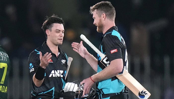 Mark Chapman and James Neesham celebrate after getting the better of Pakistan by seven wickets, Pakistan vs New Zealand, 3rd T20I, Rawalpindi, April 21, 2024. — AFP