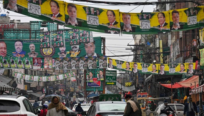 A street is festooned with posters of Pakistan´s former Prime Minister and leader of the Pakistan Muslim League (PML) party, Nawaz Sharif in Lahore on February 4, 2024, ahead of national elections. — AFP