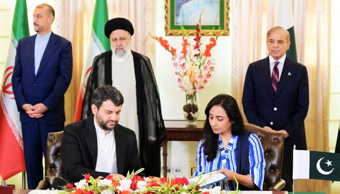 Iranian President Seyyed Ebrahim Raisi (left) and PM Shehbaz Sharif oversee a signing ceremony at the Prime Ministers Office in Islamabad on April 22, 2024. — PMO/Handout