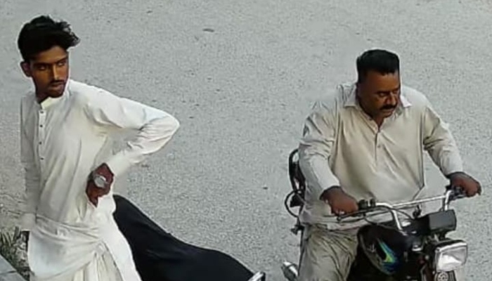 This still is taken from a viral video of suspects snatching valuables including a motorcycle and cell phone from a person in Karachis Korangi area. —reporter