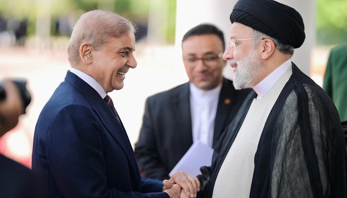 Prime Minister Shehbaz Sharif greets Iranian President Ebrahim Raisi on his three-day official visit in Islamabad, April 22, 2024. — Prime Minister Office/Handout
