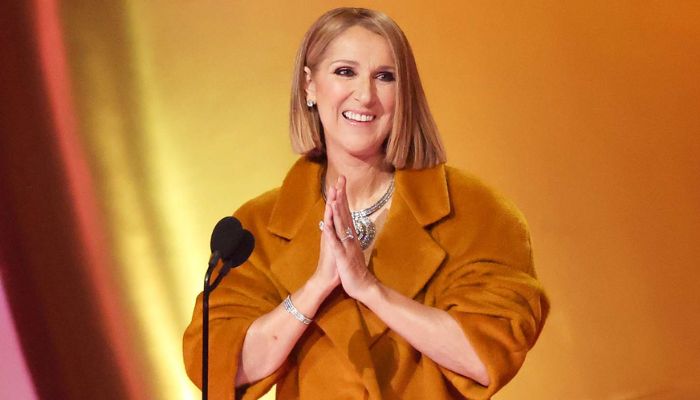Céline Dion woremustard yellow coat while presenting the award to Taylor Swift at the 2024 Grammys