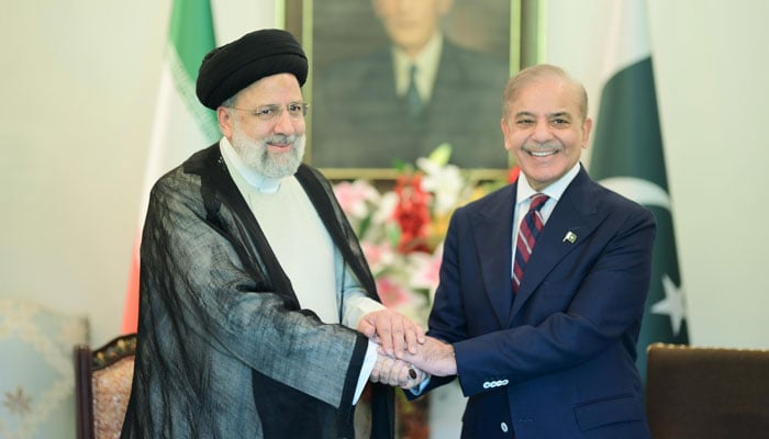 Iranian President Ebrahim Raisi (left) and Prime Minister Shehbaz Sharif greet each other during the formers three-day official visit in Islamabad, April 22, 2024. — X/@PakPMO