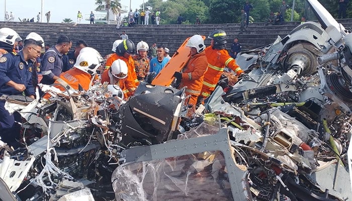 Emergency personnel work at the site of a helicopter crash in Lumut, Perak, Malaysia, April 23, 2024. — Reuters