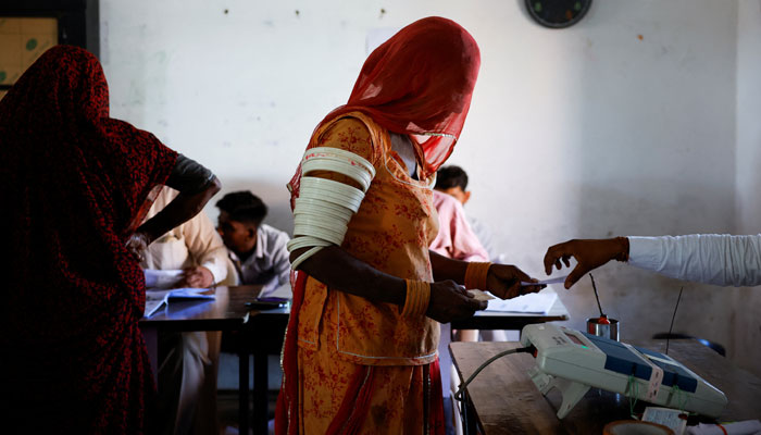 A woman votes at a polling station during the second phase of the general elections, in Barmer, Rajasthan, India, April 26, 2024. — Reuters