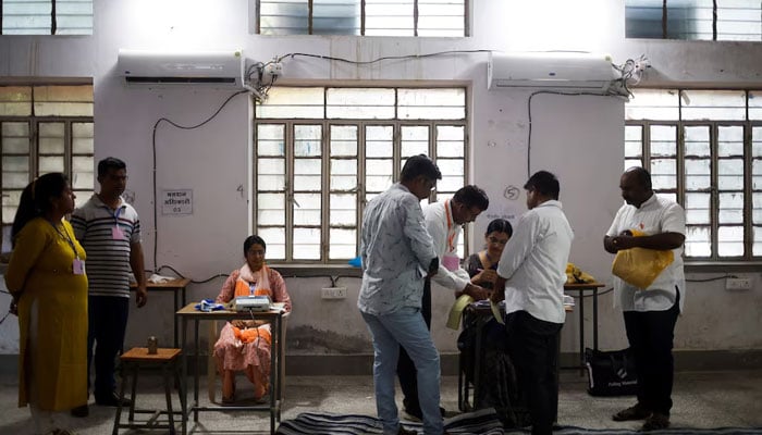 Election officials work at a polling station during the second phase of the general elections, in Barmer, Rajasthan, India, April 26, 2024. — Reuters