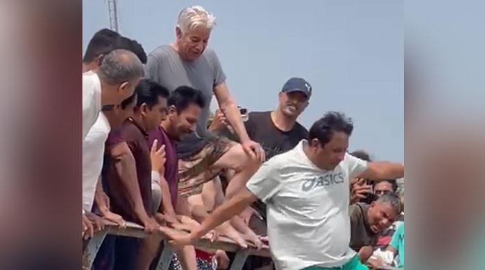 WATCH: Khawaja Asif beats the heat by dipping in Sialkot's canal 