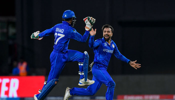 Afghanistan´s captain Rashid Khan (R) celebrates the dismissal of Bangladesh´s Rishad Hossain during the ICC men´s Twenty20 World Cup 2024 Super Eight cricket match between Afghanistan and Bangladesh at Arnos Vale Stadium in Arnos Vale, Saint Vincent and the Grenadines on June 24, 2024. — AFP
