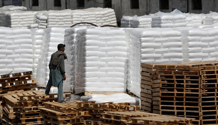 A labourer stands near the cargo supply at a warehouse near the port area in Karachi, May 13, 2020. — Reuters