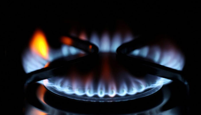 Flames come out of a domestic gas ring of an oven on September 23, 2021. — Reuters