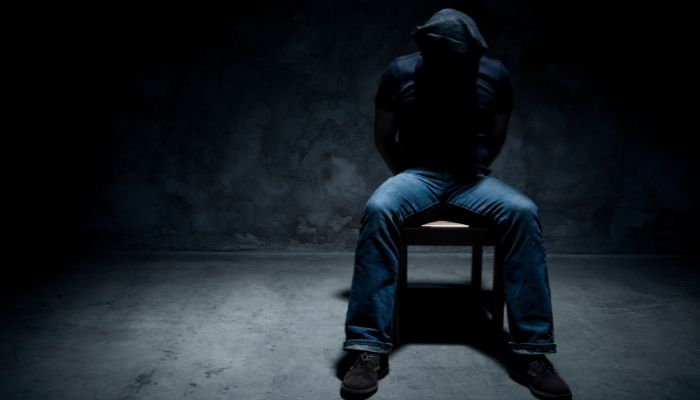 This is a representational image of a person being tortured. — Canva