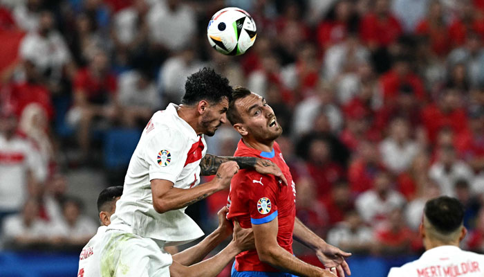 Turkeys defender #04 Samet Akaydin and Czech republics forward #19 Tomas Chory fight for the ball during the UEFA Euro 2024 Group F football match between the Czech Republic and Turkey at the Volksparkstadion in Hamburg on June 26, 2024. — AFP
