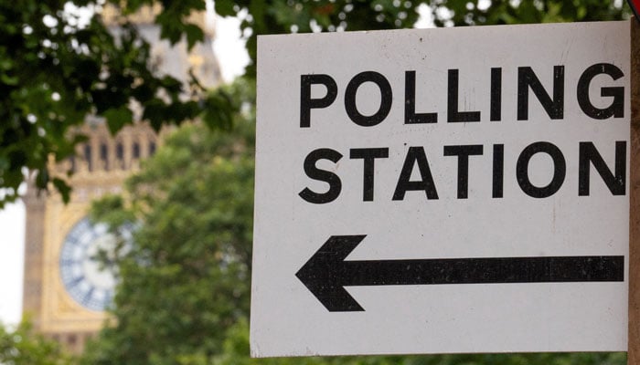 A polling station direction sign is attached to a street sign near the Elizabeth Tower, more commonly known as Big Ben, ahead of general elections, in London, Britain July 3, 2024. — Reuters