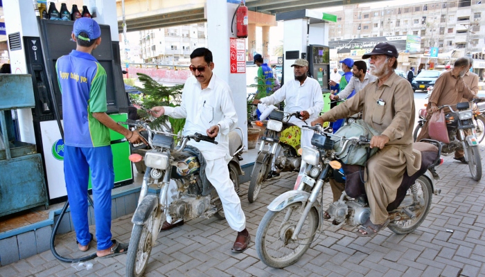 Motorcyclists waiting for their turn to fill fuel in their bikes at a petrol pump on May 16, 2024. —APP