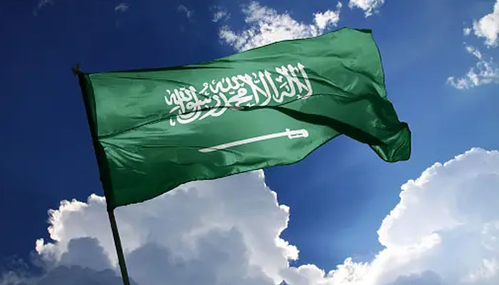 This image shows the flag of Saudi Arabia. — Unsplash