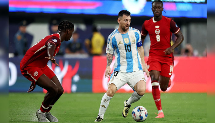 Argentinas Lionel Messi in action with Canadas Moise Bombito ON July 9, 2024. — Reuters
