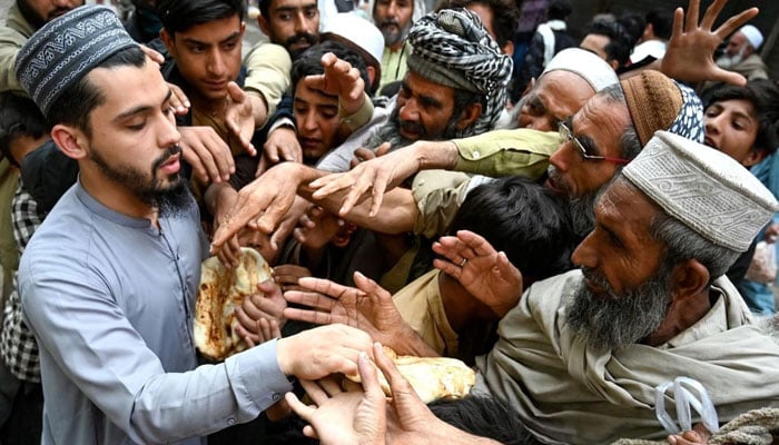 A representational image distributing free flat bread (roti) in Peshawar, Khyber Pakhtunkhwa on April 3, 2023. — AFP