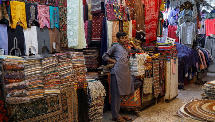 A shopkeeper stands outside his shop in a market, ahead of Eid ul Fitr celebrations in Karachi, Pakistan April 19, 2023. — Reuters
