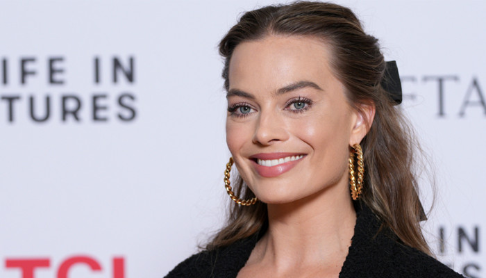 Margot Robbie flaunts her baby bump in white polka-dots dress