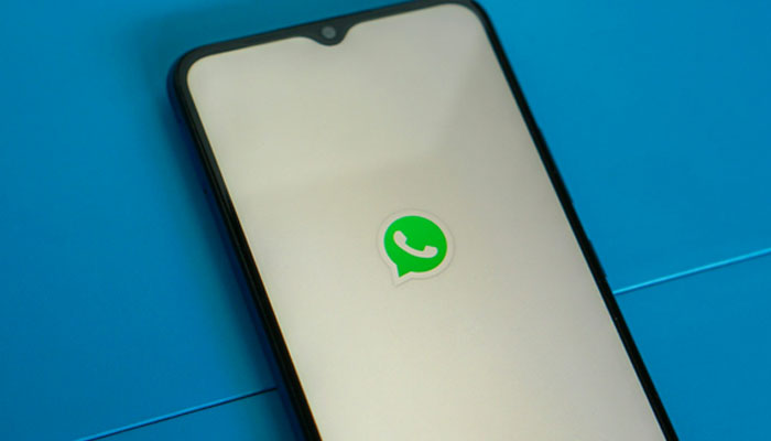 The WhatsApp logo displayed on a phone screen. — Unsplash