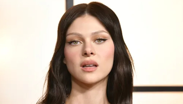 Nicola Peltz breaks down infront of a grave with her husband
