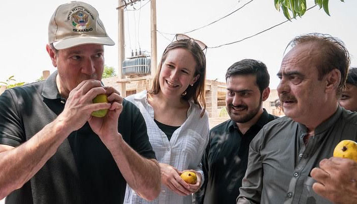 US DCM Schofer tasting the ripe and delicious mangoes at the Luftabad farm, South Punjab, Pakistan on July 31, 2024. — Supplied