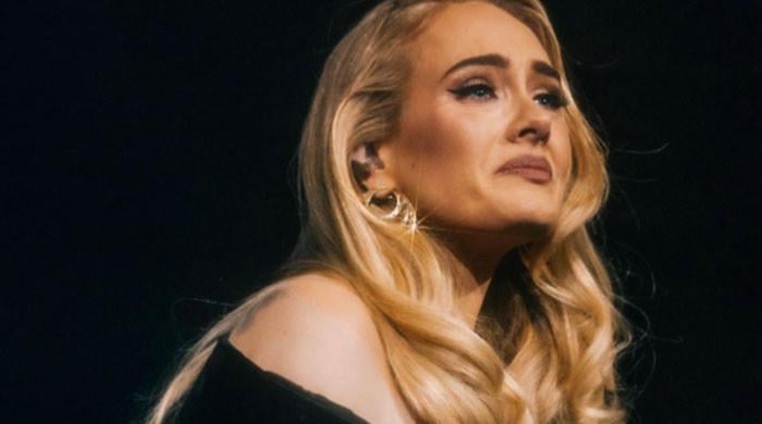 Adele shows emotional side during concert: 'I cry alone'