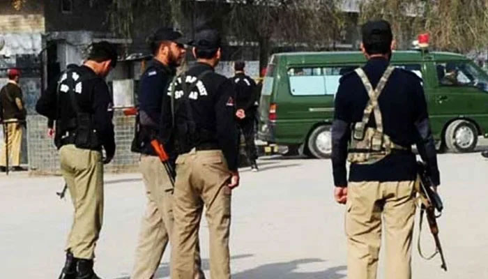 Police personnel stand guard on a road. — AFP/File