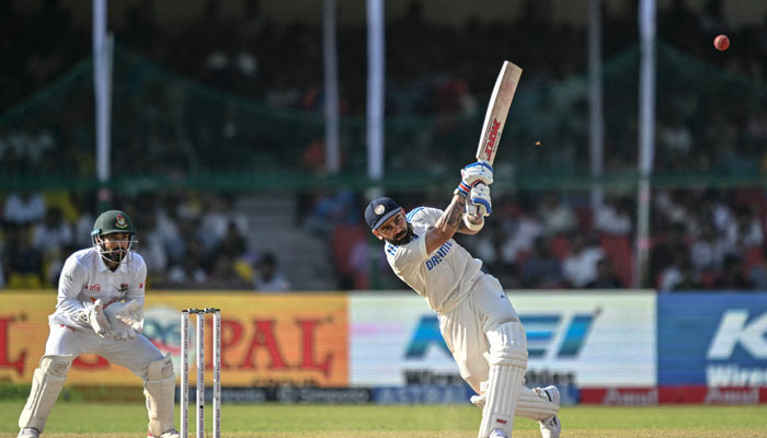 India’s Virat Kohli (right) plays a shot during the fourth day of the second Test cricket match between India and Bangladesh at the Green Park Stadium in Kanpur on September 30, 2024. — AFP