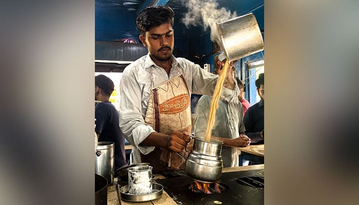 Abdul Qadir makes chai at the Khalil Bhai Chai shop in University of Karachis Prem Gali. — Photo by author