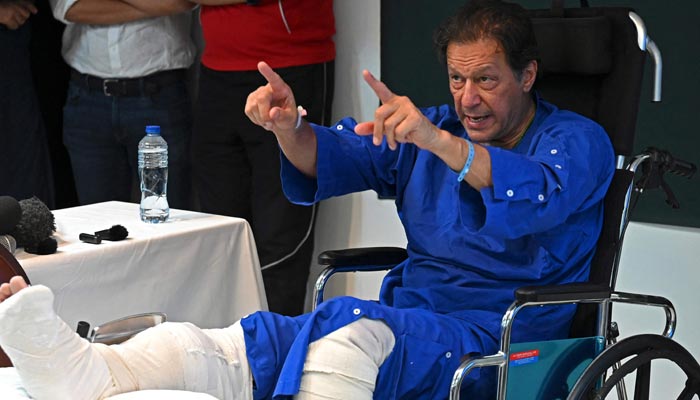 In this picture taken on on November 4, 2022, former prime minister Imran Khan addresses the media representatives at a hospital in Lahore, a day after an assassination attempt on him. — AFP