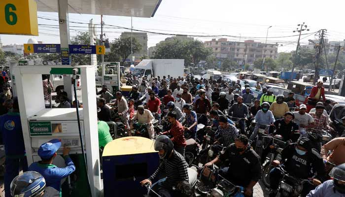 Motorcyclists wait for their turn to fill up with gasoline at a gas station. — Reuters/File