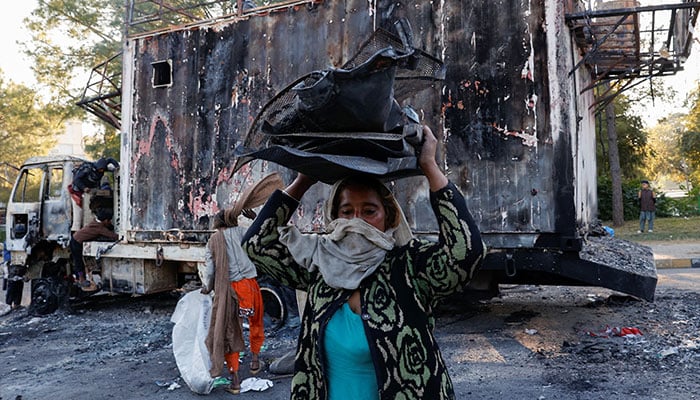 PTI's Yousafzai calls for internal investigation after abrupt end to protest 8 Women and children collect recyclables from the burnt truck used by Bushra Bibi after security forces launched a raid on supporters of PTI in Islamabad, Pakistan, November 27, 2024. — Reuters