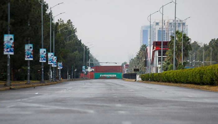 Shipping containers are kept on the main highway to prevent an anti-government rally by supporters of PTI founder Imran Khan in Islamabad on November 24, 2024. — Reuters