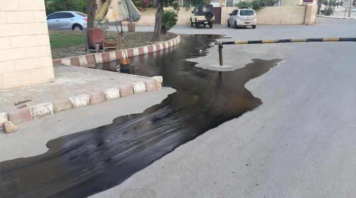 Oil from damaged refinery pipeline spills on road near Sea View Oil from damaged refinery pipeline spills on road near Sea View