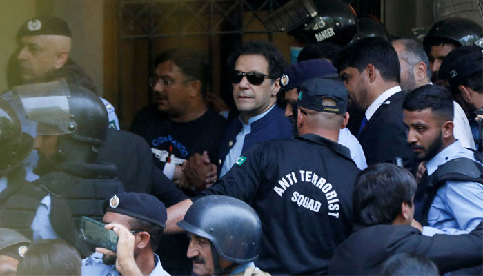 Security officers escort Pakistans former Prime Minister Imran Khan, as he appeared in Islamabad High Court, Islamabad May 12, 2023. — Reuters