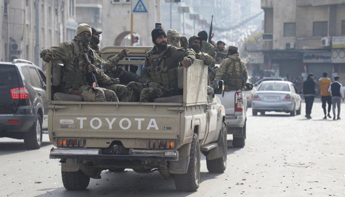 Rebel fighters board a vehicle, after HTS-led rebels sought to capitalize on their rapid takeover of Aleppo in the north and Hama in west-central Syria by heading towards Homs , in Hama, Syria, December 6, 2024. — Reuters