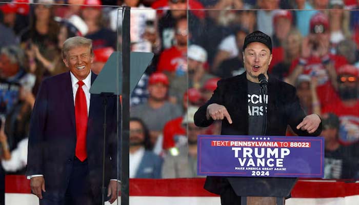 Donald Trump (left) reacts as Tesla CEO and X owner Elon Musk speaks during a rally in Butler, Pennsylvania, US on October 5, 2024. — Reuters
