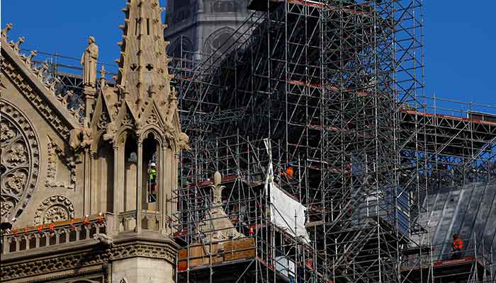 Construction workers are seen on scaffolding at the Notre-Dame de Paris Cathedral in Paris, France, December 4, 2024. — Reuters