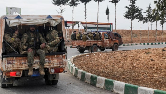 Rebel fighters sit on a vehicle in Homs, Syria, on December 7, 2024. — Reuters